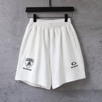 White drawstring shorts with elastic waistband and front Balenciaga logo patch