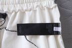 White shorts close-up with black care label tag on the side