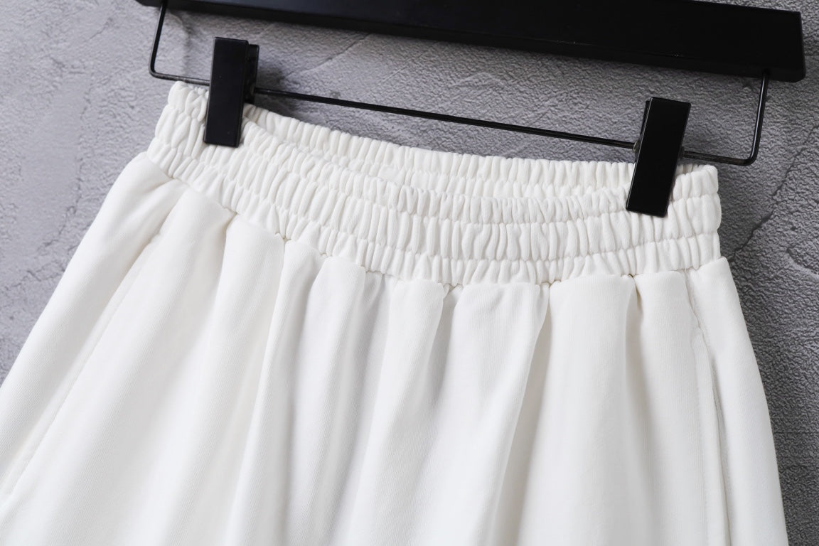 White shorts on a hanger with elastic waistband detailing