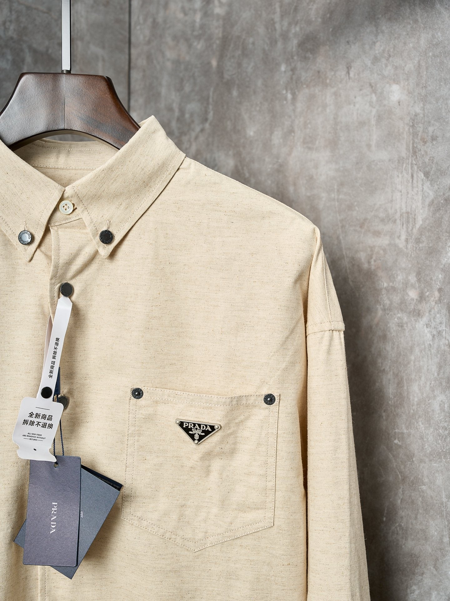 Cream long-sleeve button-up shirt with Prada triangle logo patch