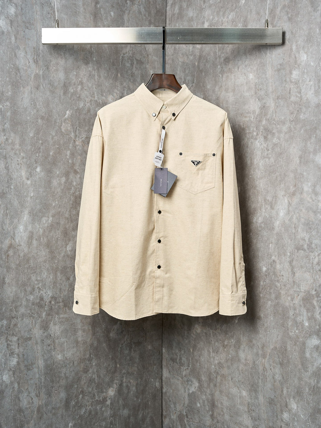 Cream long-sleeve button-up shirt with Prada logo patch and chest pockets
