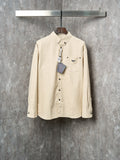 Cream long-sleeve button-up shirt with Prada logo patch and chest pockets