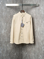 Cream long-sleeve button-up shirt with Prada logo patch and chest pockets