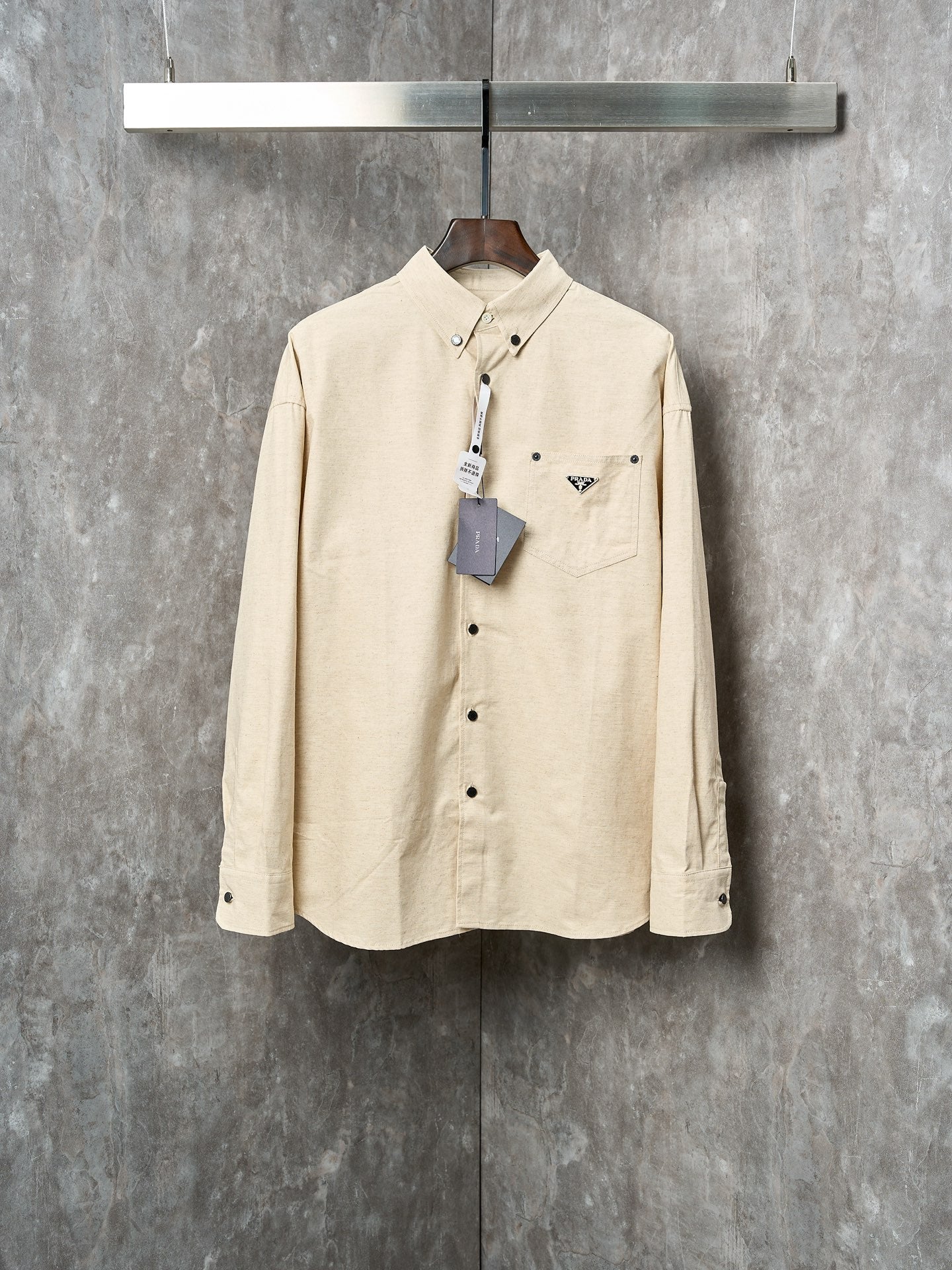 Cream long-sleeve button-up shirt with Prada logo patch and chest pockets