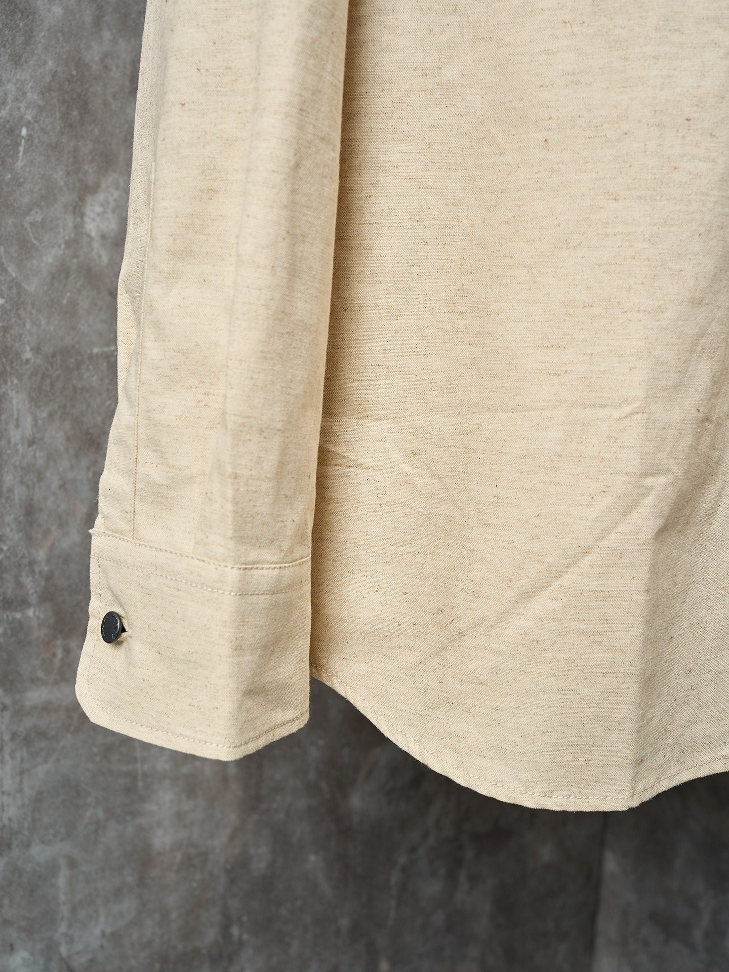 Cream long-sleeve shirt with dark cuff button