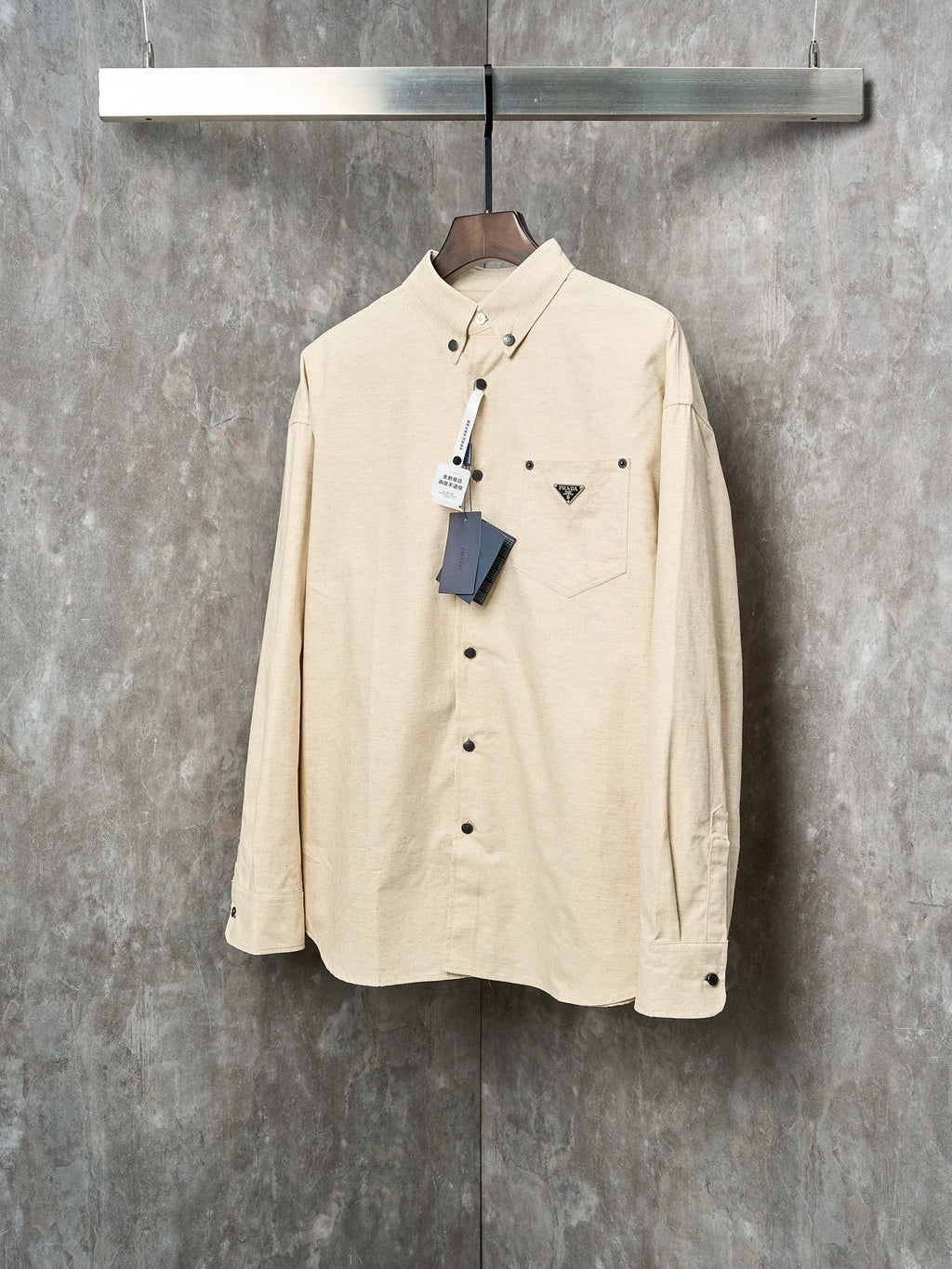 Cream long-sleeve button-up shirt with Prada triangle logo patch