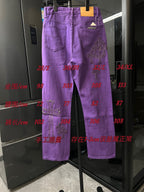 Purple chrome pants with embroidered cross patches, front full view on display