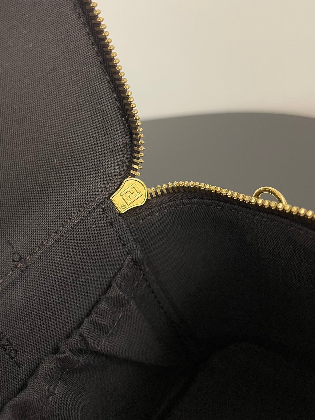 Fendi mini bag interior lining with logo patch and gold zipper trim