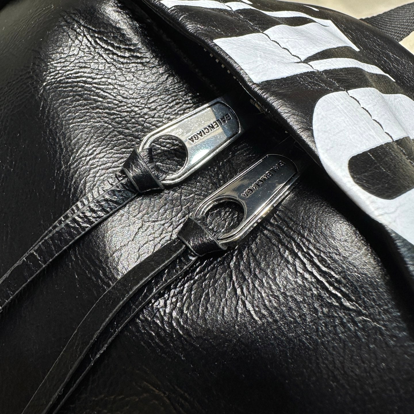 Balenciaga men’s backpack strap attachment with metal rings and small logo patch