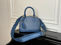 Blue Louis Vuitton handbag with two top handles, textured exterior, gold hardware.