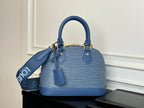Blue Louis Vuitton handbag front view with two top handles and leather side tabs.