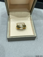 Gold-tone braided ring with sparkling stones in a jewelry box