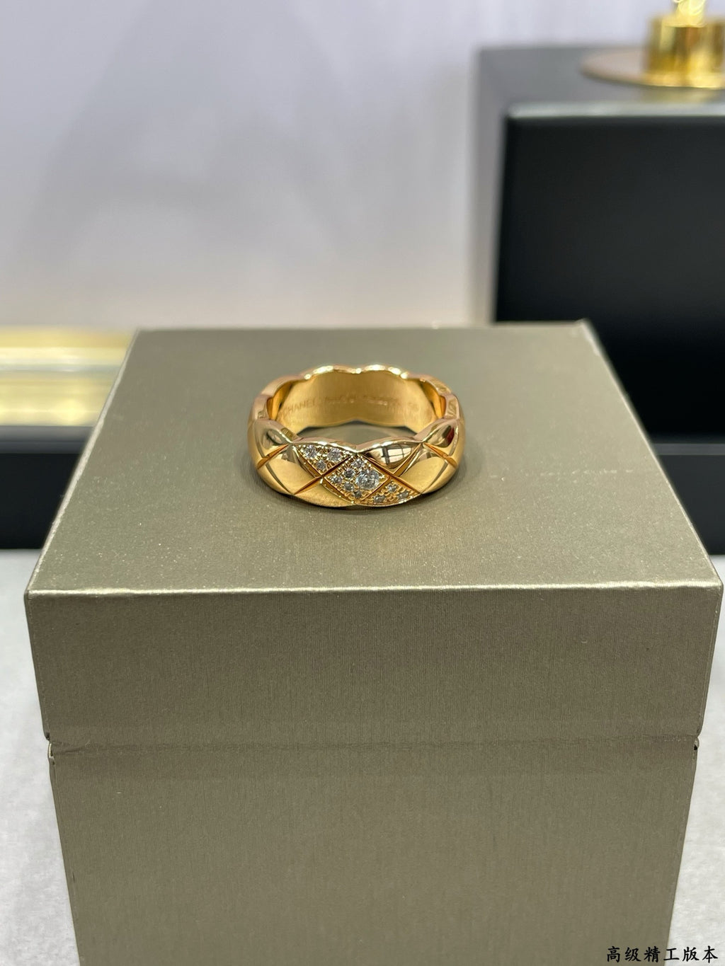 Gold-tone braided ring with cross-over design and sparkling stones on display