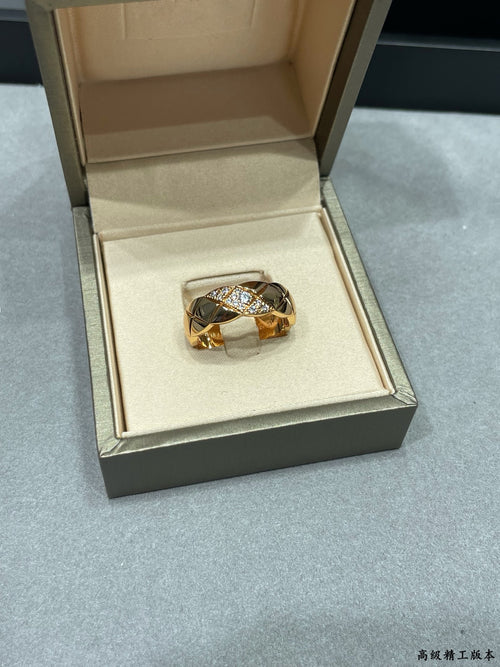 Gold- and silver-tone braided ring with sparkling stones in a jewelry box