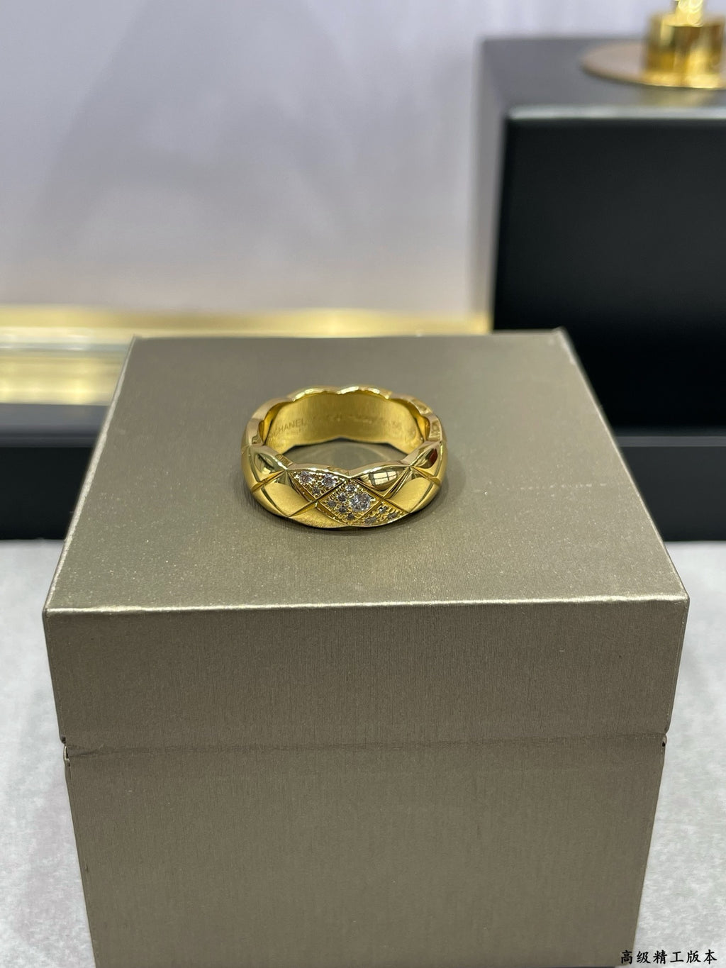 Gold-tone braided cross-over ring with sparkling stones on display
