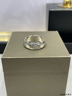 Silver-tone braided ring with cross-over design and sparkling stones on display