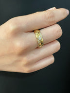 Gold-tone braided ring with sparkling stones, worn on an open hand