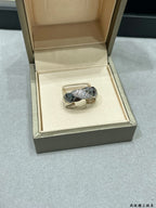 Silver-tone braided ring with sparkling stones in a jewelry box