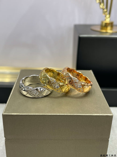 Set of three stacked rings with gold and silver tones on a display box