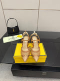 Pointed-toe heeled sandals with woven tan straps and ankle sling, gold heel.