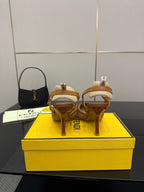 Tan woven heeled sandals with thin straps and slender heel, FENDI logo on insole.