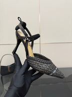 Fendi ladies heeled sandal shoes shown on hand, black textured upper and stiletto heel