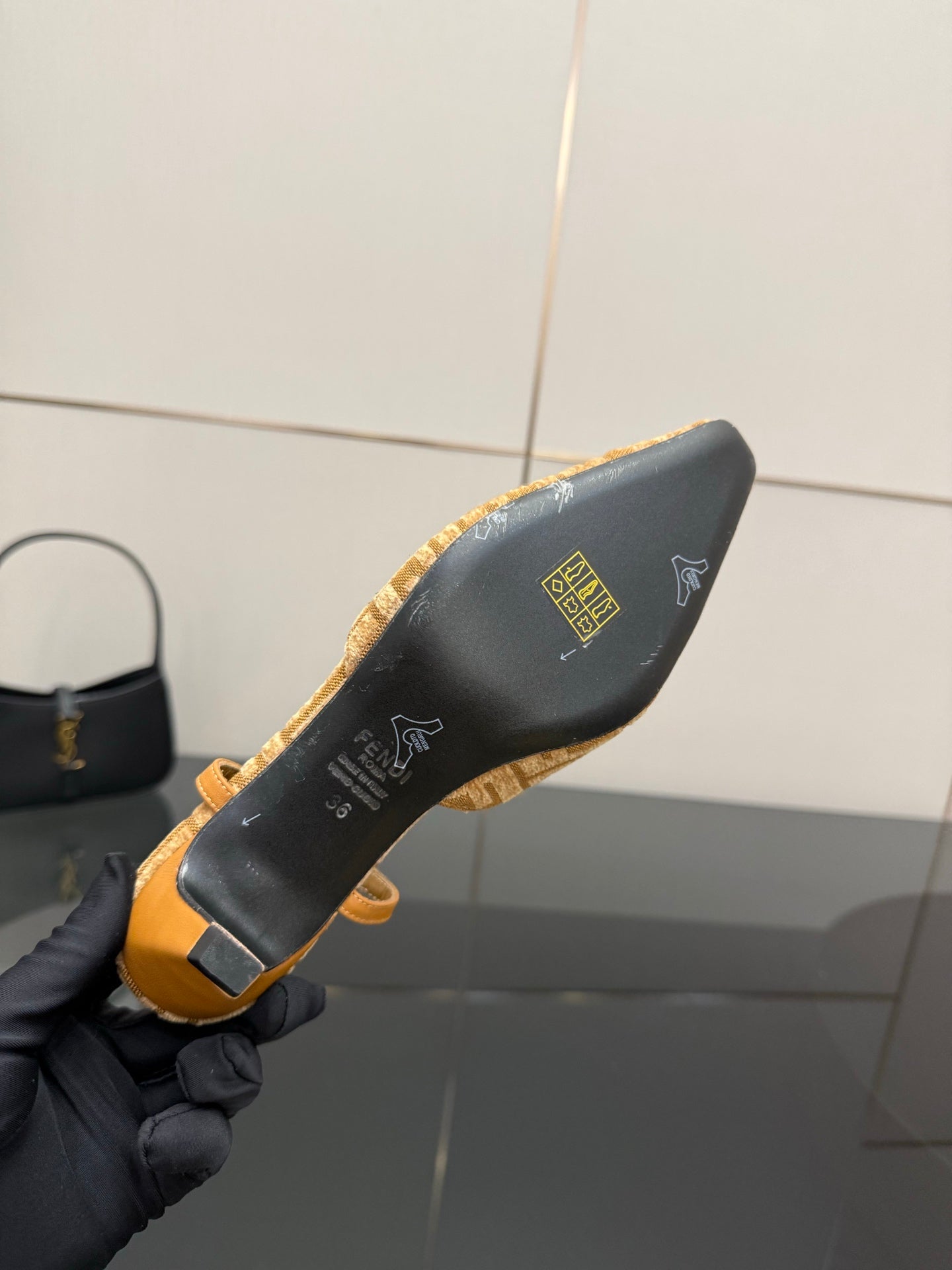 Fendi ladies slingback shoes side view with black lining and gold logo detailing