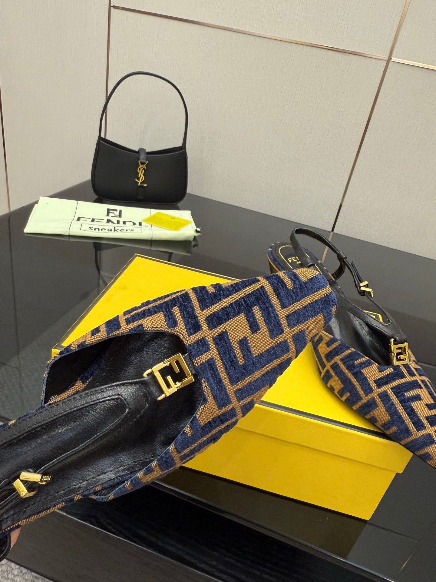 Close-up of women’s FF-pattern slingback flats with ankle strap and gold logo hardware
