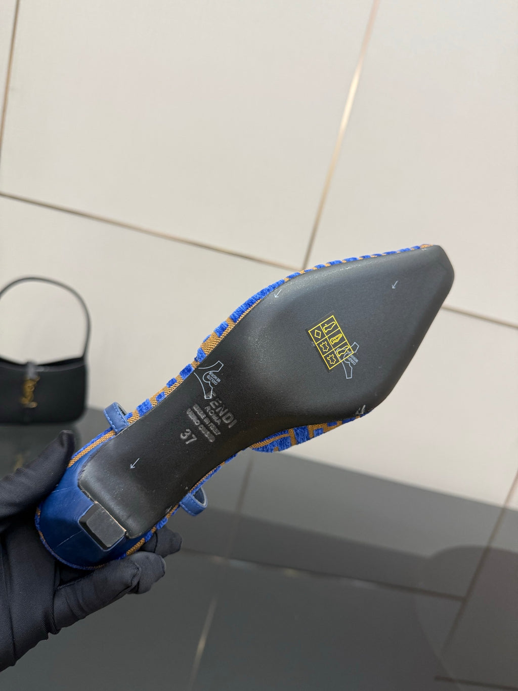 Blue and black Fendi logo-pattern slingback pump heel base close-up