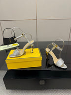 Fendi ladies silver heeled sandals with open straps, gold buckle, and clear support