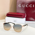 Gold metal round sunglasses with dark tinted lenses and sculpted bridge