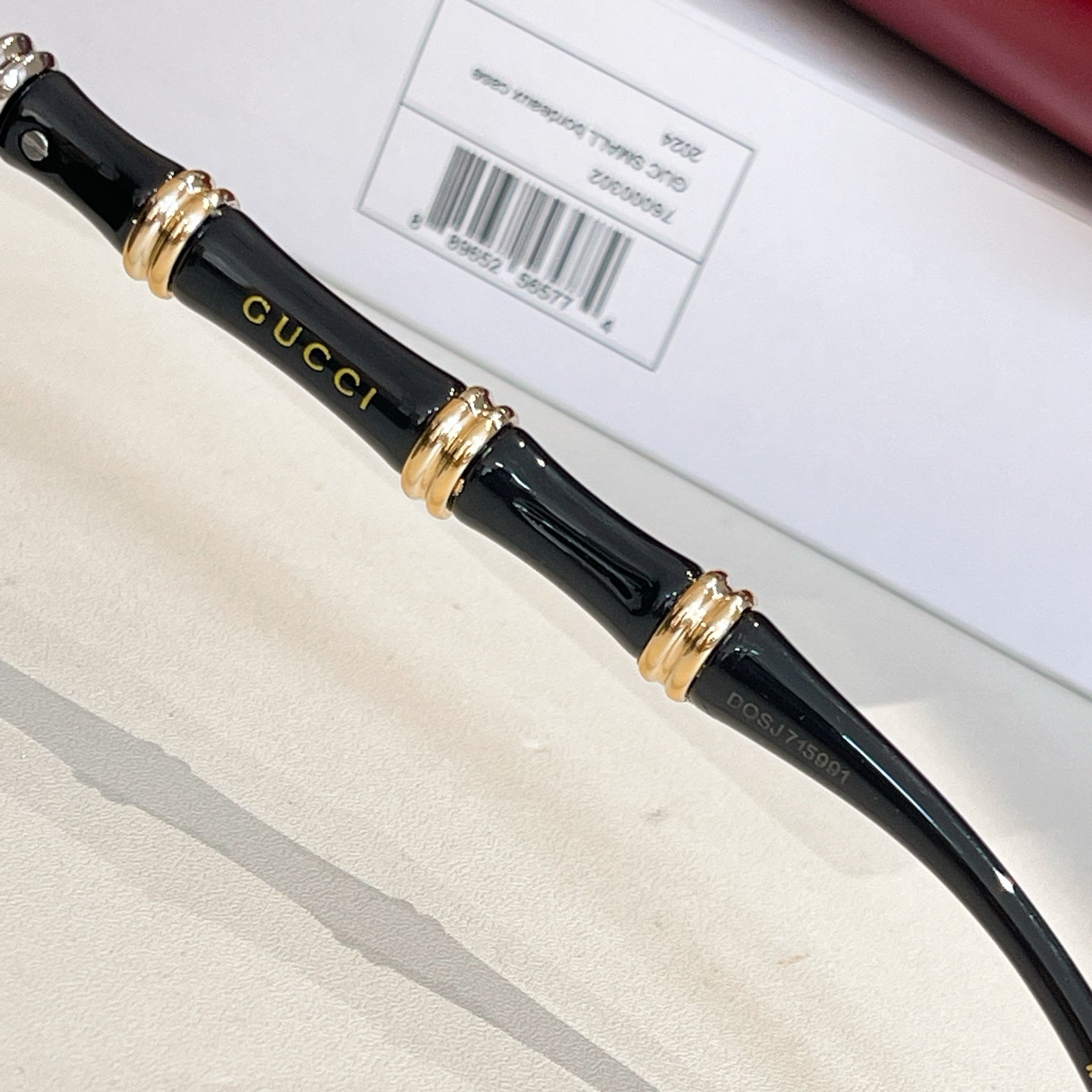 Black sunglasses temples with gold hardware and Gucci script detail