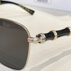 Gold and black temple detail with round dark-tinted lens