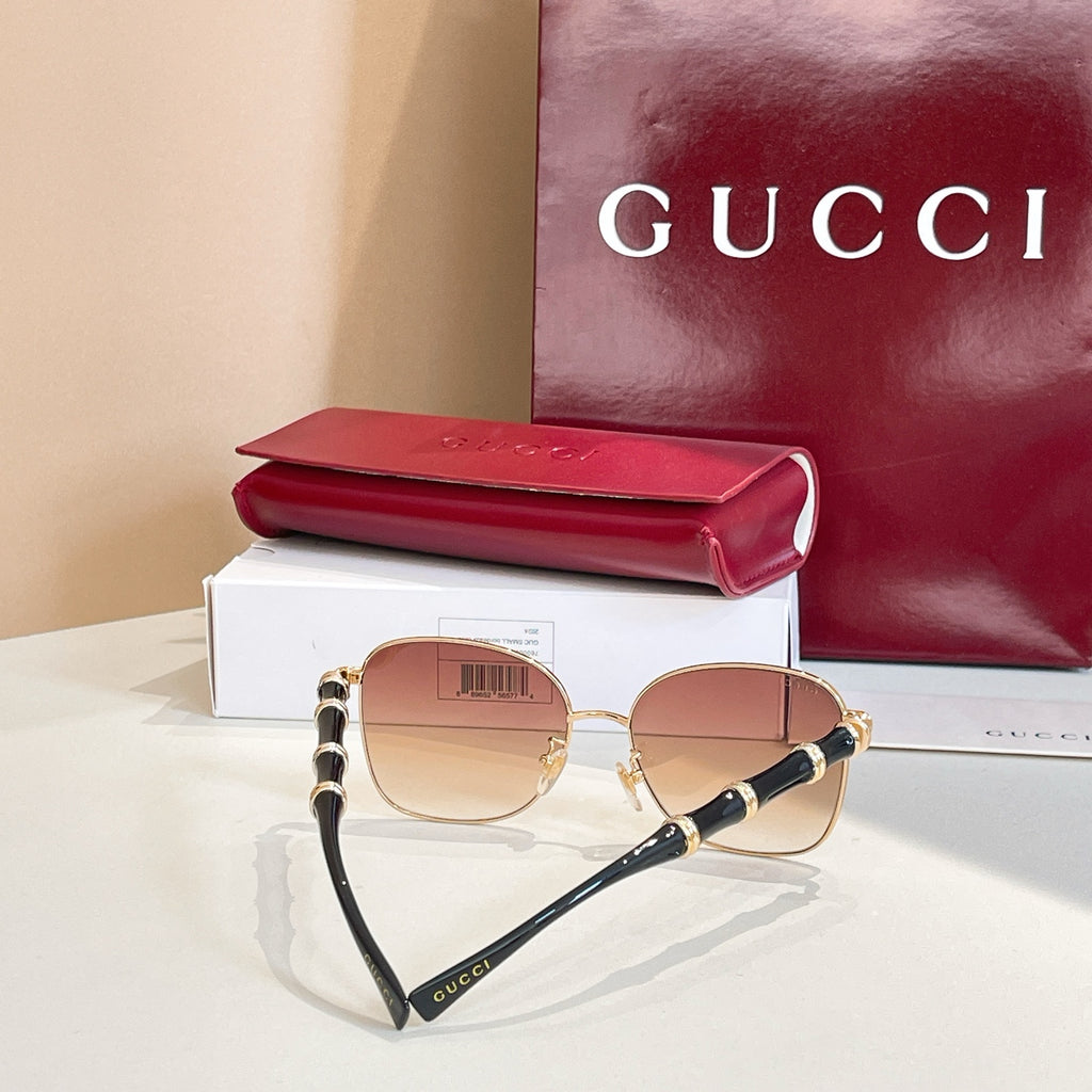 Gucci round sunglasses with gold frame, tinted lenses, black temples