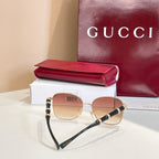 Gucci round sunglasses with gold frame, tinted lenses, black temples