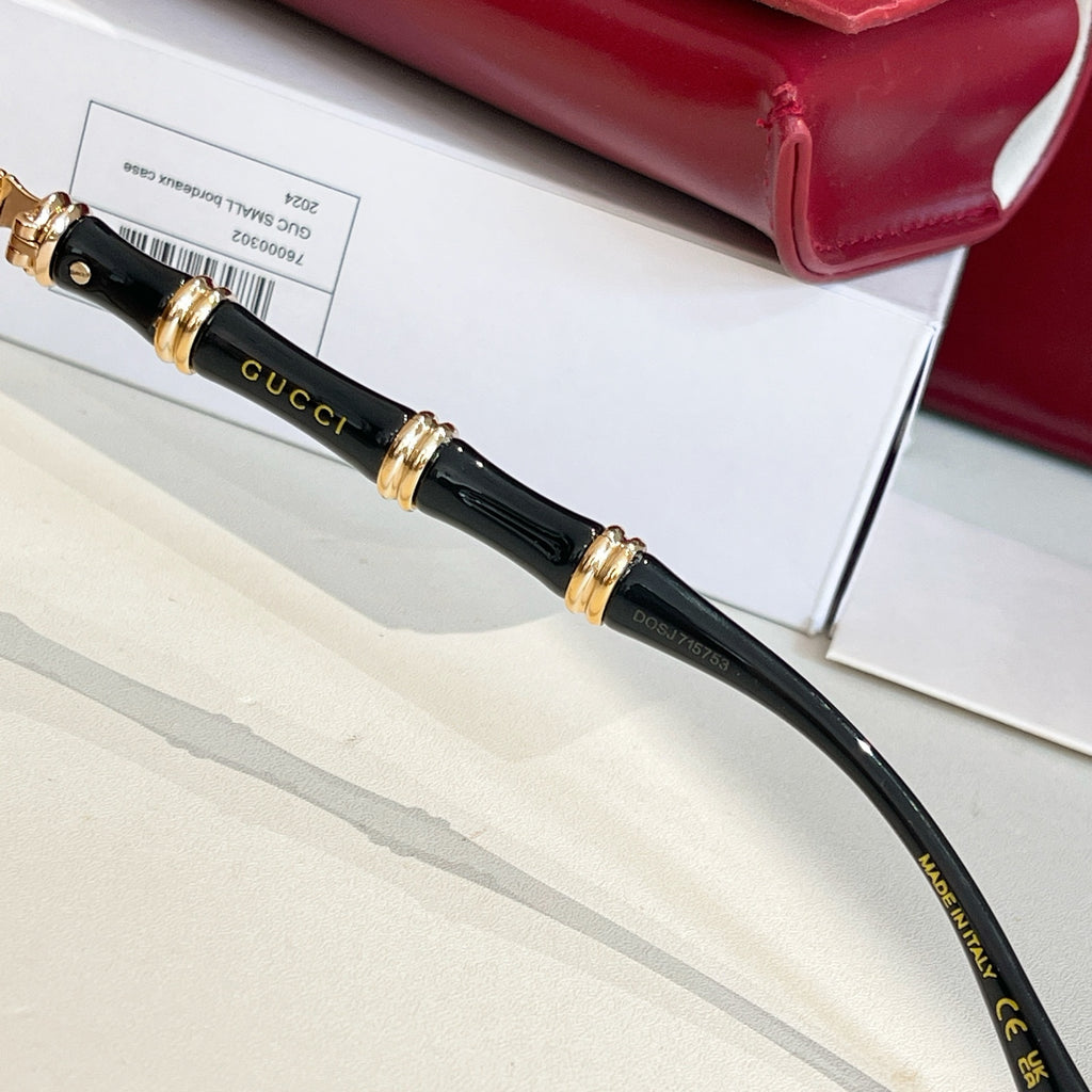 Gucci glasses black temple with gold logo accents and hinge