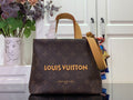 Louis Vuitton bag in dark brown monogram canvas with tan top handles and strap