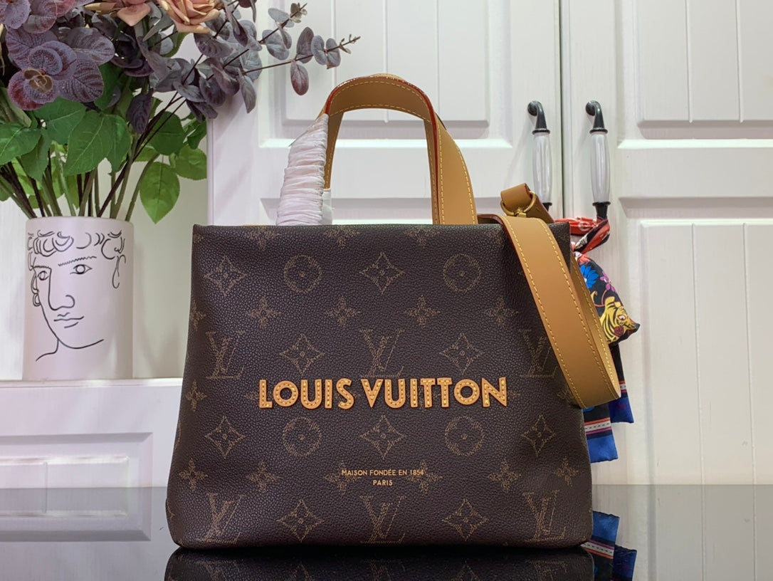 Louis Vuitton bag in dark brown monogram canvas with tan top handles and strap
