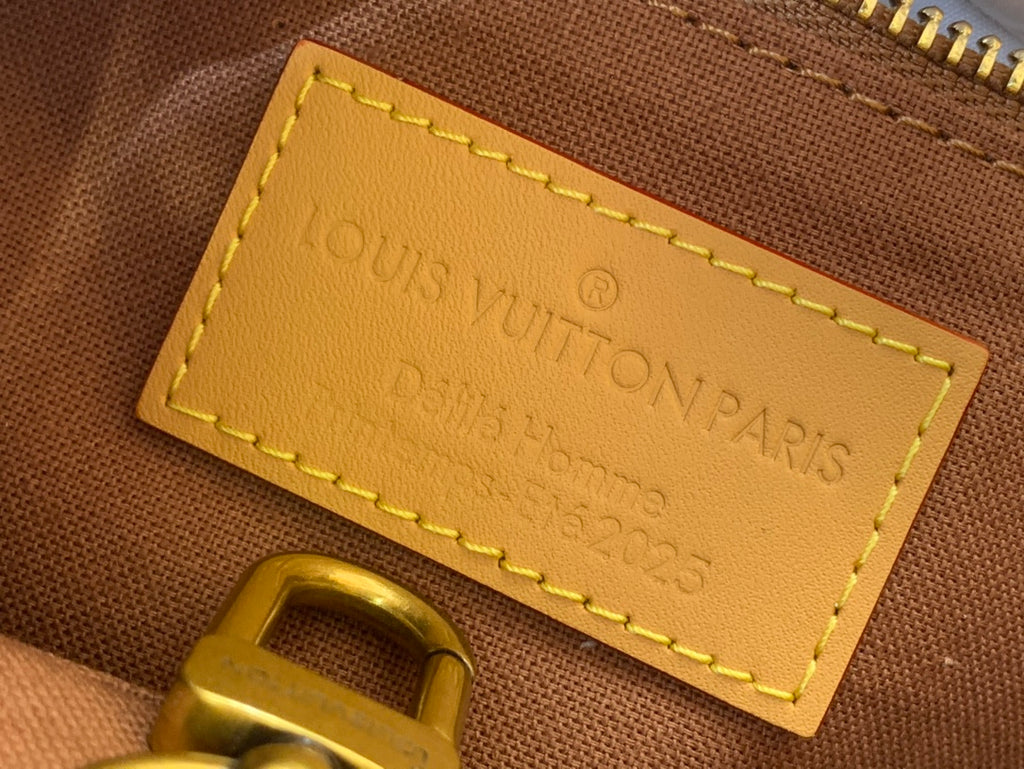 Louis Vuitton Paris leather tag with yellow stitching on brown bag lining