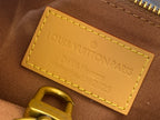 Louis Vuitton Paris leather tag with yellow stitching on brown bag lining