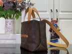 Louis Vuitton bag with tan handles and shoulder strap, dark brown monogram canvas