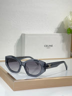 Celine sunglasses with black frames, tinted lenses, and gold logo on the side