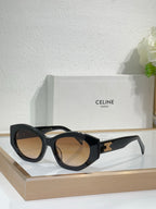 Celine sunglasses with black frames and warm tan lenses, featuring a gold temple logo