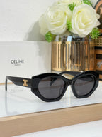 Celine sunglasses with black oversized frames, dark lenses, and gold temple emblem