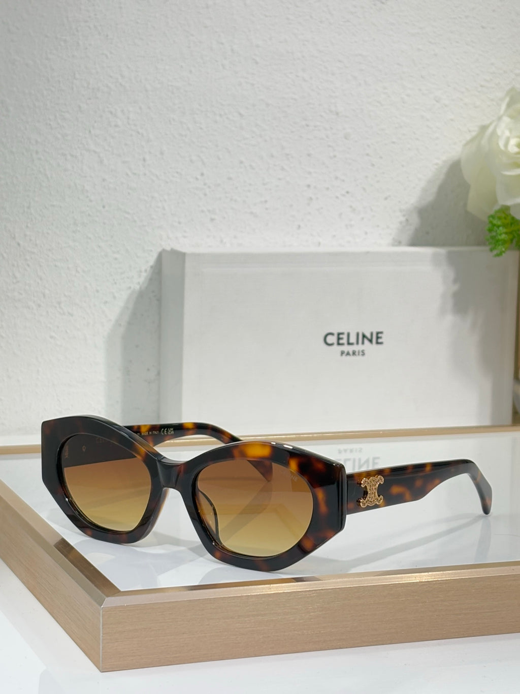 Celine tortoiseshell sunglasses with rounded frames, amber-tinted lenses, and gold logo