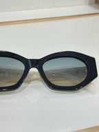 Close-up of Celine sunglasses with black oval frames and tinted lenses