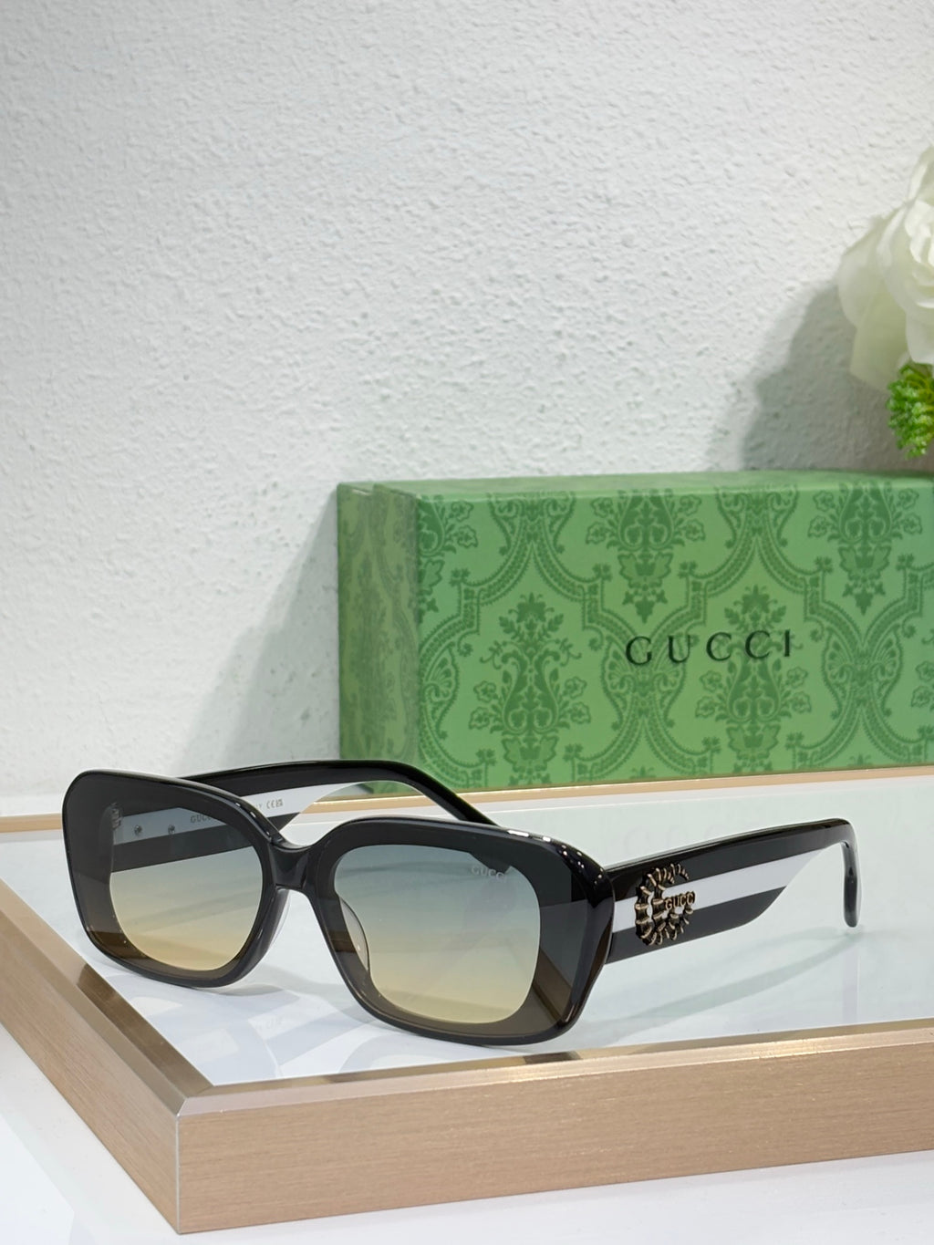 Gucci sunglasses with black frames and tinted blue lenses, cat-eye silhouette