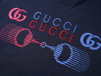 Navy T-shirt chest graphic with Gucci text and GG logos in red and blue