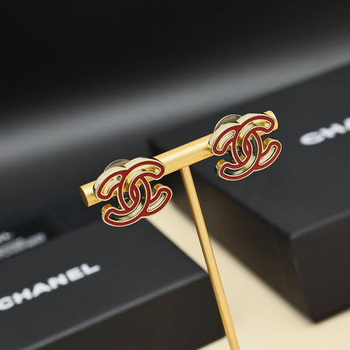 Chanel earrings, gold-tone sticks with red-and-gold CC logo studs