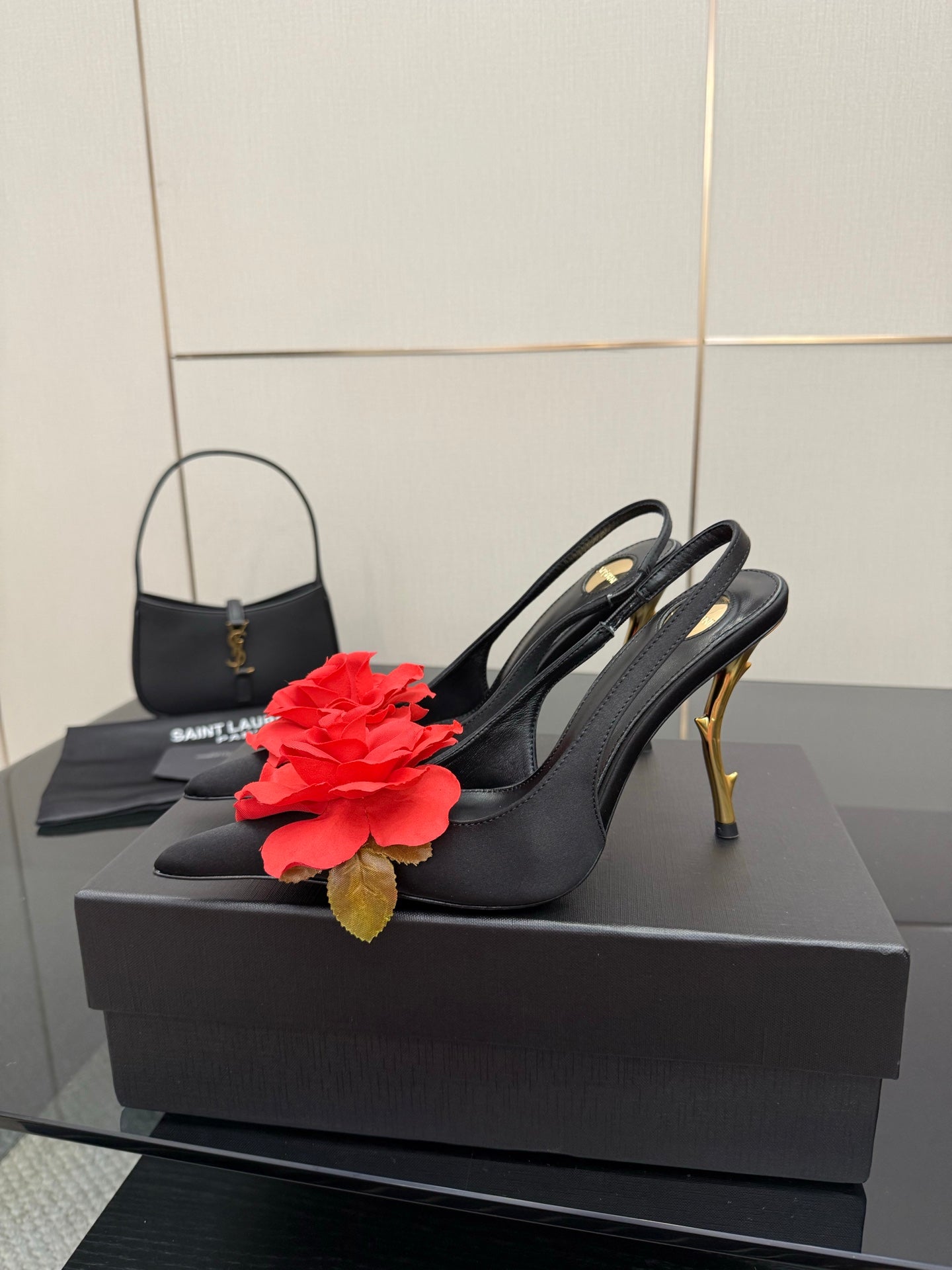 Black slingback heel with red rose clip and gold stiletto heel, single shoe